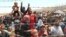 Syrian refugees, flee intense fighting in northern Syria between Kurdish fighters and Islamic State militants, are seen massed at the Turkish border in Akcakale, southeastern Turkey, June 15, 2015.