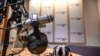 FILE - A microphone and headsets are seen in a radio broadcast studio.