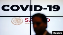 A screen displays the term COVID-19 during a news conference in Mexico City, Mexico, Feb. 27, 2020. 