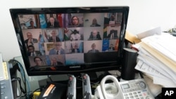 U.N. Secretary-General Antonio Guterres, second from right bottom on a computer monitor at U.N. headquarters, participates in a virtual meeting of the Security Council during the 75th session of the U.N. General Assembly, Sept. 24, 2020.