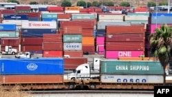 FILE - Container trucks arrive at the Port of Long Beach in Long Beach, Calif., August 23, 2019. Washington is moving ahead Sept. 1, 2019, with new tariffs on Chinese imports.