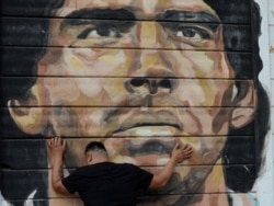 A fan reacts while mourning the death of soccer legend Diego Armando Maradona, outside the Diego Armando Maradona stadium, in Buenos Aires, Argentina, Nov. 25, 2020.