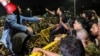 Protesters sit on the barricade placed in front of the Bangabhaban, the residence and workplace of the president, as they shout slogans demanding the resignation of President Mohammed Shahabuddin in Dhaka, Bangladesh, on Oct. 22, 2024.