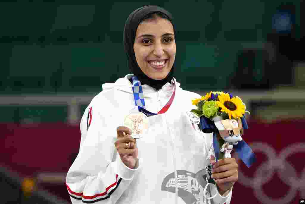 Bronze medalist Giana Lotfy of Egypt poses during the medal ceremony for women&#39;s kumite -61kg karate at the 2020 Summer Olympics, Friday, Aug. 6, 2021, in Tokyo, Japan. (AP Photo/Vincent Thian)