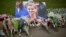 An image and floral tributes for Jo Cox, the 41-year-old British Member of Parliament shot to death yesterday in northern England, lie placed on Parliament Square outside the House of Parliament in London, June 17, 2016. 