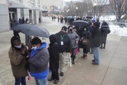 People line up outside Yankee stadium for vaccines amid the coronavirus disease (COVID-19) pandemic in the Bronx borough of New York City, New York, Feb. 5, 2021.