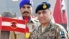 Former Lieutenant General Faiz Hamid, right, shown here in an undated photo provided by Pakistan's Inter-Services Public Relations, was charged with several criminal offenses, the Pakistani military announced on Dec. 10, 2024.