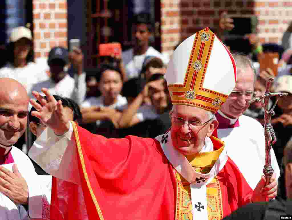 Pope Francis leaves after celebrating a Mass at St Mary's Cathedral in Yangon