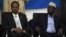 Somalia's newly elected President Hassan Sheikh Mohamud and his predecessor, Sharif Sheikh Ahmed (R), listen to proceedings after the election, in Mogadishu, Somalia, September 10, 2012.