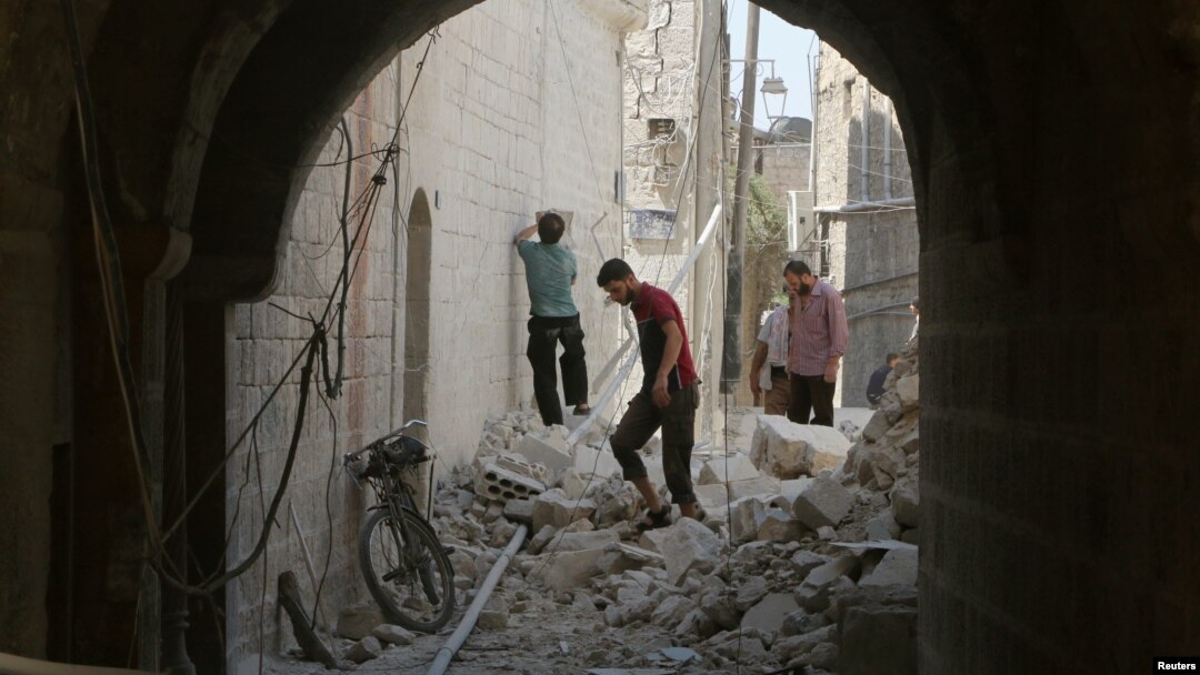 Residents inspect their damaged homes after an airstrike on the rebel-held Old Aleppo, Syria, Aug. 15, 2016.