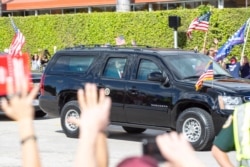 U.S. President Donald Trump is seen as his motorcade drives past supporters on Southern Boulevard on their way to Mar-a-Lago in Florida, Jan. 20, 2021.