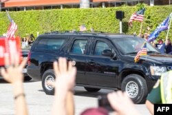 U.S. President Donald Trump is seen as his motorcade drives past supporters on Southern Boulevard on their way to Mar-a-Lago in Florida, Jan. 20, 2021.
