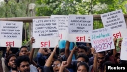 Students display placards and shout slogans during a protest against the scrapping of the special constitutional status for Kashmir by the government, in New Delhi, Aug. 8, 2019.