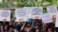 Students display placards and shout slogans during a protest against the scrapping of the special constitutional status for Kashmir by the government, in New Delhi, Aug. 8, 2019.
