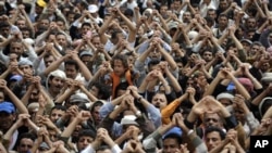 Anti-government protesters gesture during a demonstration demanding the resignation of Yemeni President Ali Abdullah Saleh, in Sana'a, March 16, 2011