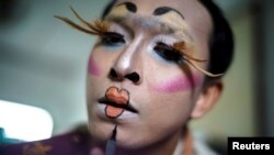 Teerapong Meesataya, 29, known as teacher Bally applies make up before his English class at the Prasartratprachakit School in Ratchaburi Province, Thailand, July 10, 2019.