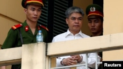 Former PetroVietnam chairman Nguyen Xuan Son is escorted by police as he leaves court after the verdict session in Hanoi, Vietnam, Sept. 29, 2017.