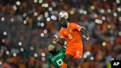 Ivory Coast 's Seko Fofana duels for the ball with Nigeria's Victor Osimhen during the final of the 2023 African Cup of Nations, at the Olympic Stadium of Ebimpe in Abidjan, February 11, 2024.
