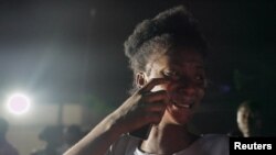 A woman reacts outside JFK Hospital where injured people have been taken after a car rammed into supporters of the Unity Party and Liberia's newly-elected President Joseph Boakai while celebrating his win, in Monrovia, Liberia, November 21, 2023. 