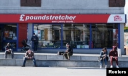 People practice social distancing in Woolwich as the spread of the coronavirus disease continues, in London, April 4, 2020.