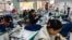 This photo taken on February 20, 2025 shows employees working in a clothing sewing workshop in Guangzhou, China's southern Guangdong province.