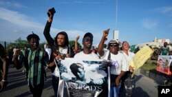 FILE - People chant slogans during a protest on the streets of Lagos, Nigeria, Thursday, Sept. 21, 2023, to demand justice following the mysterious death of afrobeats star Mohbad. 