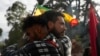 People embrace during a protest in front of the prosecutor's office following the disappearance in Guayaquil of four children who were last seen running away from a military convoy, in Quito, Ecuador, Dec. 23, 2024.