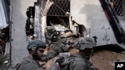 FILE - Israeli soldiers take part in a ground operation in Gaza City's Shijaiyah neighborhood, December 8, 2023. 