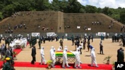 Pallbearers carry the coffin of a government minister, Dr. Ellen Gwaradzimba, who died of COVID-19, at the Heroes Acre in Harare, Jan. 21, 2021. As of Jan. 23, Zimbabwe had lost four Cabinet ministers and several senior officials to the virus.