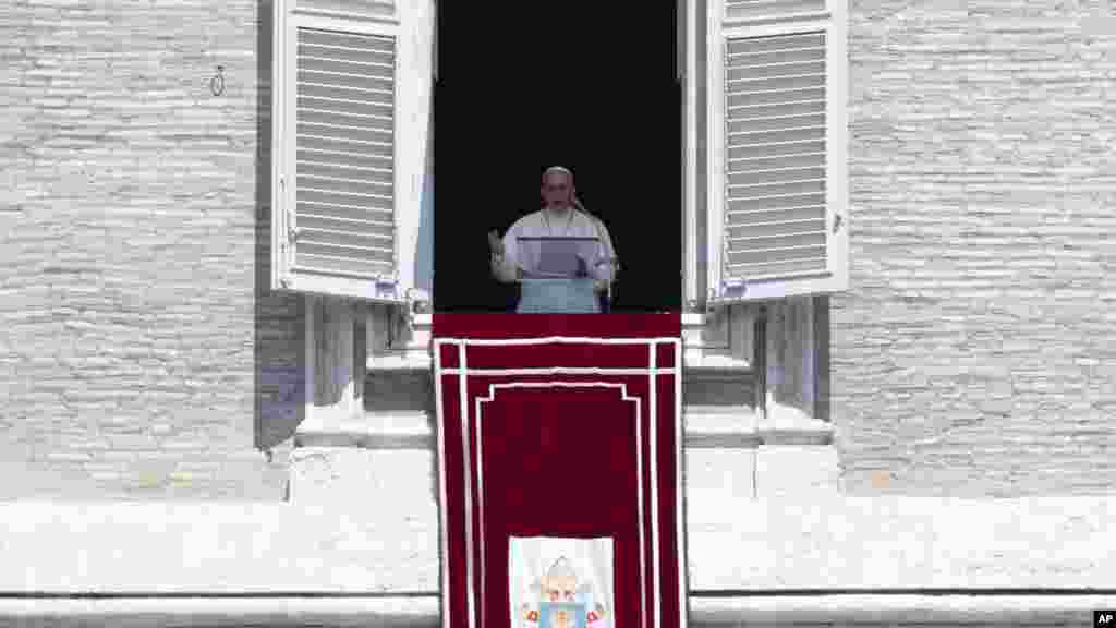 Pope Francis urged the international community to find a solution to the problems in Iraq on Sunday. Here, he delivers his blessing during the Angelus noon prayer he celebrated from the window of his studio overlooking St. Peter&#39;s Square, at the Vatican, Aug. 10, 2014. &nbsp;