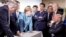 In this photo made available by the German Federal Government, German Chancellor Angela Merkel, center, speaks with U.S. President Donald Trump, seated at right, during the G7 Leaders Summit in La Malbaie, Quebec, Canada, on June 9, 2018.