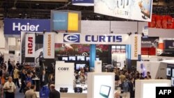 People walk around the trade show floor during the Consumer Electronics Show Friday, Jan. 7, 2011, in Las Vegas.