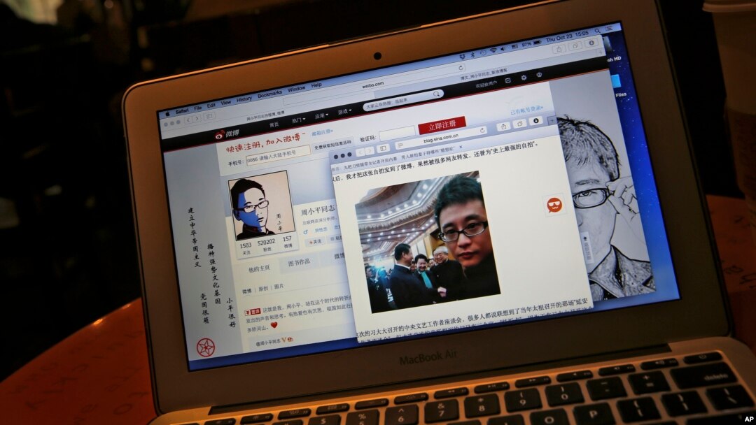This screen shot shows Chinese Patriotic Blogger, Zhou Xiaoping's Sina Weibo account and his selfie near Chinese President Xi Jinping with officials at the Great Hall of the People, in his blog, in Beijing, China Thursday, Oct. 23, 2014. 
