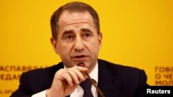 FILE - Mikhail Babich, Russian Ambassador to Belarus speaks during a news conference devoted to the 5th anniversary of Crimea's annexation by Russia, in Minsk, Belarus, March 18, 2019. 
