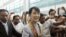 Myanmar's pro-democracy leader Aung San Suu Kyi makes her way through the Yangon International Airport as she leaves for her trip to Europe June 13, 2012.