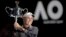 Denmark's Caroline Wozniacki holds her trophy aloft after defeating Romania's Simona Halep in the women's singles final at the Australian Open tennis championships in Melbourne, Australia, Jan. 27, 2018.
