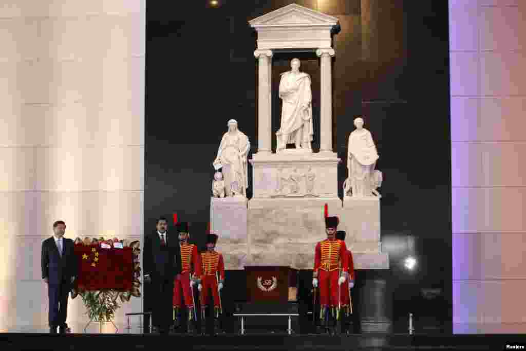 Chinese President Xi Jinping, left, and Venezuelan President Nicolas Maduro, second from left, attend a ceremony at the tomb of the national hero Simon Bolivar at the National Pantheon in Caracas, July 20, 2014.