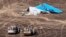 In this photo made available Monday, Nov. 2, 2015, and provided by Russian Emergency Situations Ministry, Egyptian Military on cars approach a plane's tail at the wreckage of a passenger jet bound for St. Petersburg in Russia that crashed in Hassana, Egypt, on Sunday, Nov. 1, 2015.