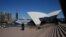 FILE - The mostly deserted steps of the Sydney Opera House, where scheduled public performances have been canceled due to the coronavirus disease (COVID-19), are seen on a quiet morning in Sydney, Australia, March 18, 2020.