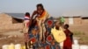 FILE - A Turkana woman washes her face at a water point within Kalobeyei Settlement outside the Kakuma refugee camp in Turkana county, northwest of Nairobi, Kenya, Feb. 1, 2018. 