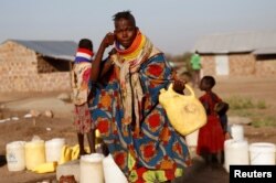 FILE - A Turkana woman washes her face at a water point within Kalobeyei Settlement outside the Kakuma refugee camp in Turkana county, northwest of Nairobi, Kenya, Feb. 1, 2018.