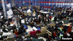 Migrants gather at a transport and logistics center near the Belarusian-Polish border in the Grodno region, Belarus, Belarus, Nov. 19, 2021. 