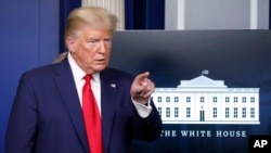 FILE - President Donald Trump points to a reporter for a question as he speaks in the James Brady Press Briefing Room of the White House, in Washington, March 31, 2020. 