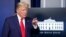 FILE - President Donald Trump points to a reporter for a question as he speaks in the James Brady Press Briefing Room of the White House, in Washington, March 31, 2020. 