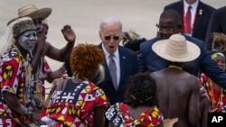 U.S. President Joe Biden watches a traditional dance after arriving at Catumbela airport in Angola, Dec. 4, 2024.