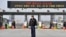  A South Korean security guard stands on the road leading to North Korea's Kaesong joint industrial complex, in front of the closed gate of the inter-Korean transit office in the border city of Paju on April 8, 2013. 