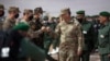 Gen. Stephen J. Townsend, head of the U.S. Africa Command, center, arrives alongside General Belkhir el-Farouk, right, Moroccan Southern Zone Commander, to watch a large scale drill as part of the African Lion military exercise, June 18, 2021.