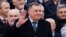 Bosnia's member of tripartite presidency Milorad Dodik waves to people during parade celebrations to mark their autonomous Serb Republic's national holiday, in Banja Luka