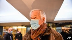 European Commission's chief negotiator Michel Barnier wears a face mask as he leaves his hotel to head back to Brussels, in London, Dec. 5, 2020.