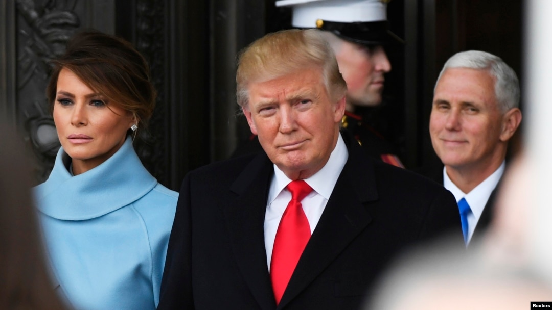 Presiden Donald Trump dan Melania Trump meninggalkan lokasi pelantikan di Gedung Capitol, 20 Januari 2017. Wakil Presiden Mike Pence di sebelah kanan.